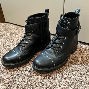 Women’s black combat boots.